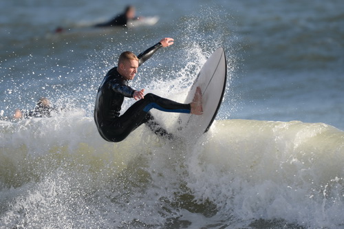 Surfer at the top of wave, gower