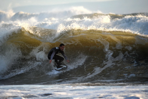 Tucking in the falling lip of a stormy wave