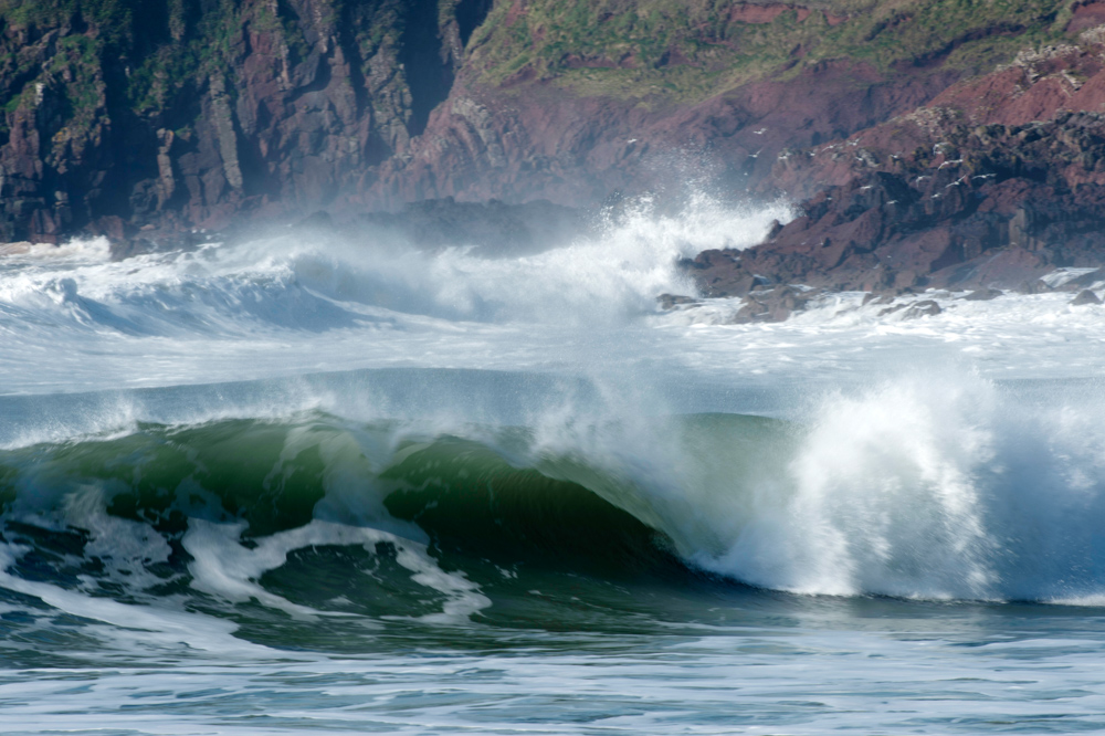 Tubing wave red sandstone cliffs