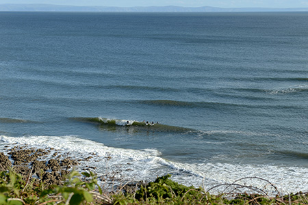 overview blue reef waves and surfers